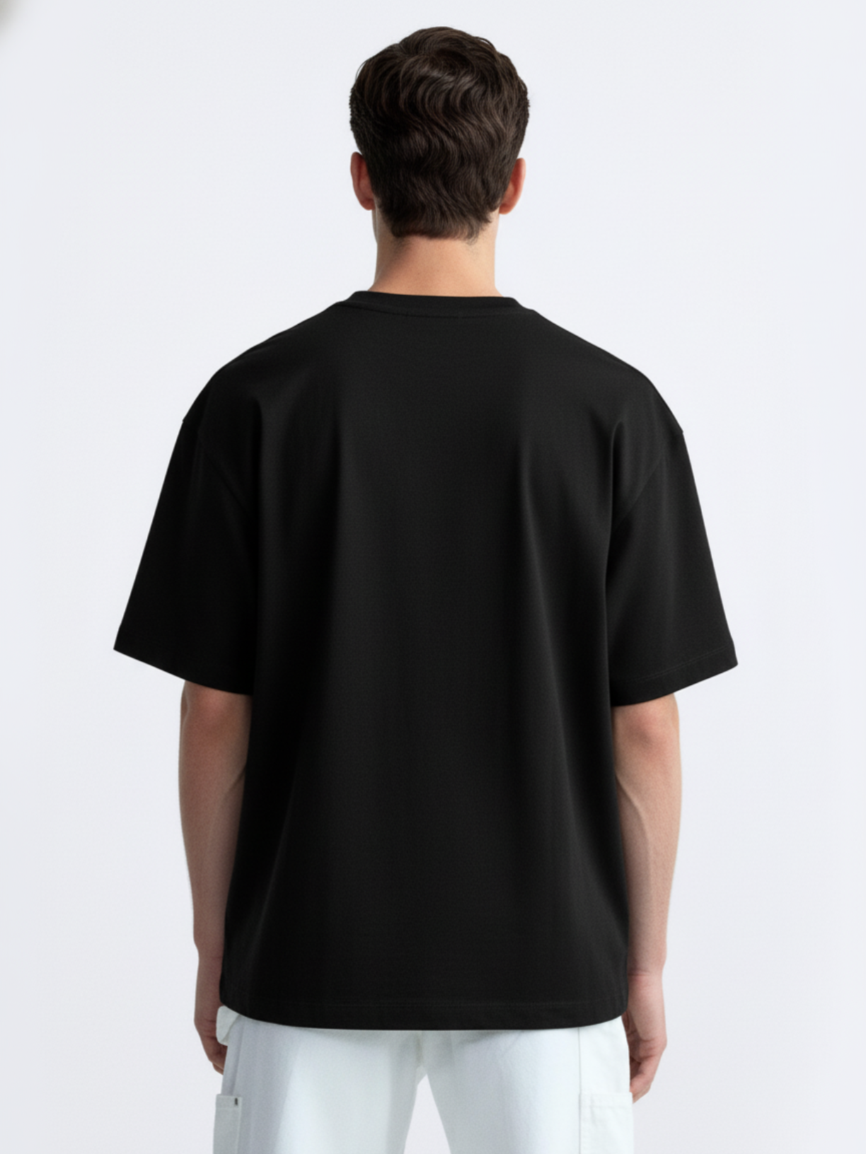 Person wearing a black t-shirt on a white background