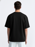 Person wearing a black t-shirt on a white background