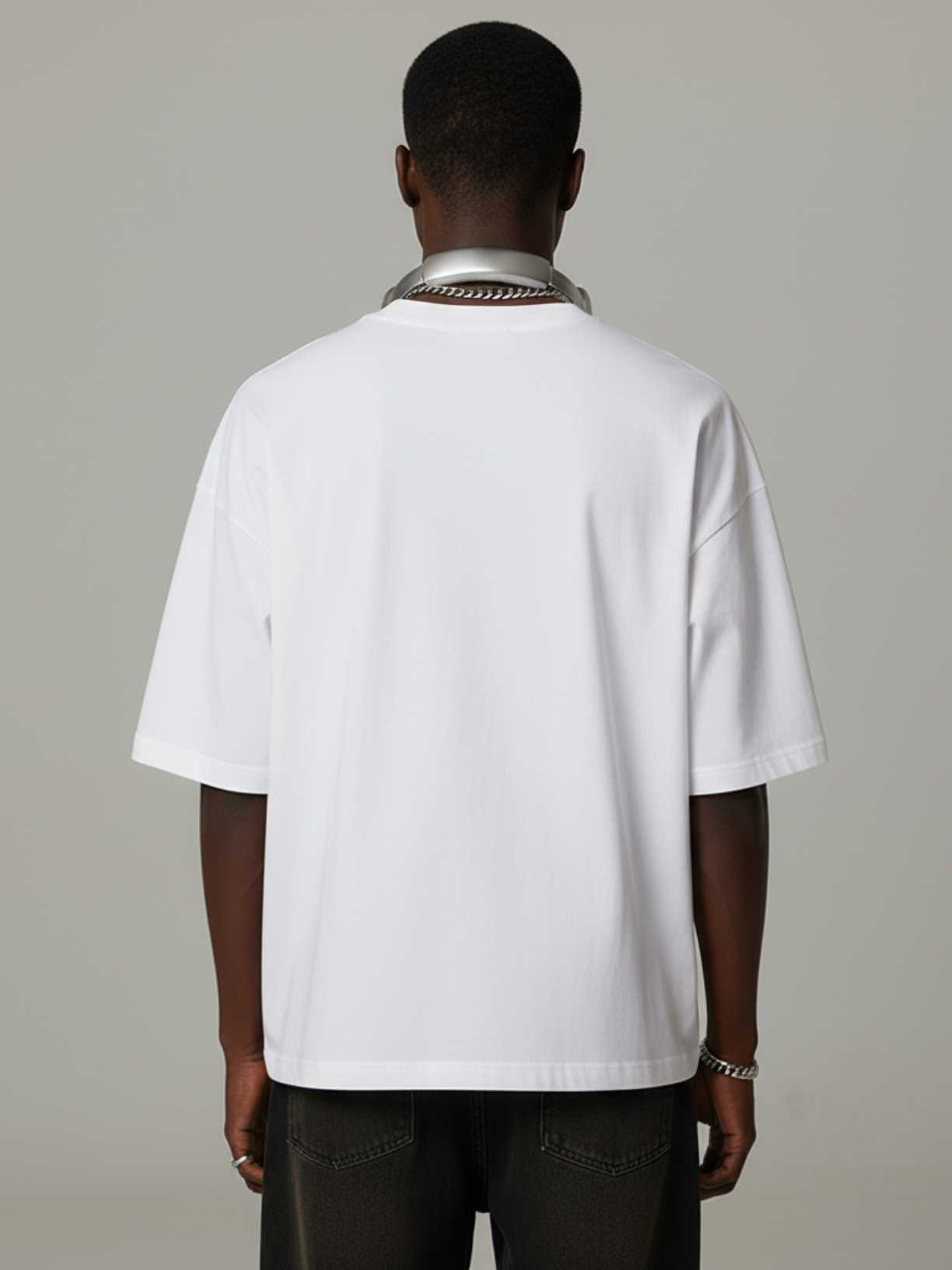 Person wearing a white shirt with a gray background