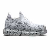 Side shot of White and grey knit Torino Grey sneakers with black paint-splatter design and cushioned sole.