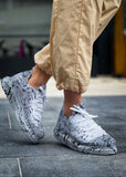 White and grey knit Torino Splatter Grey sneakers with black paint-splatter design and cushioned sole.