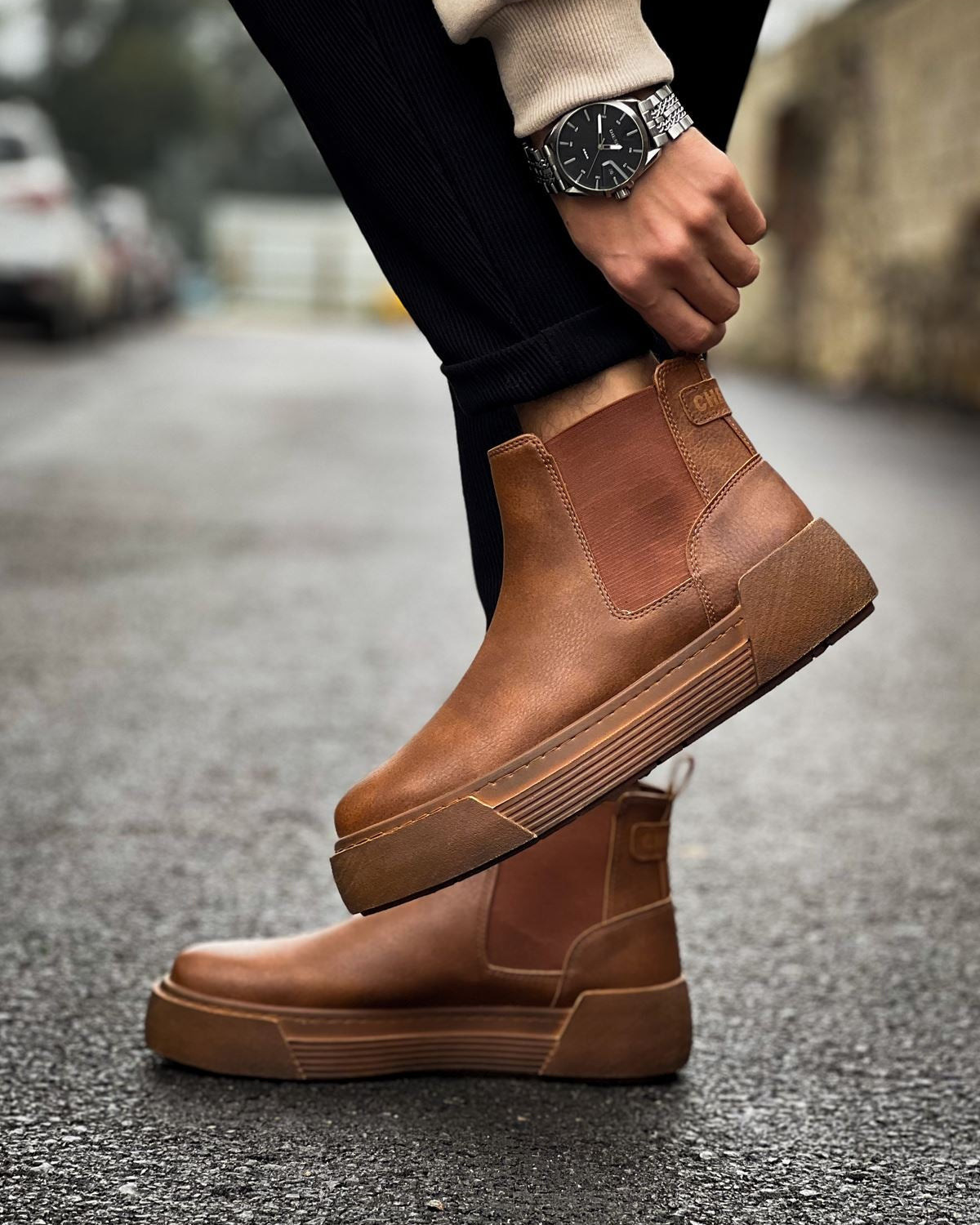 Man wearing Avalon Light Brown Chelsea boots with cushioned platform sole on wet pavement.