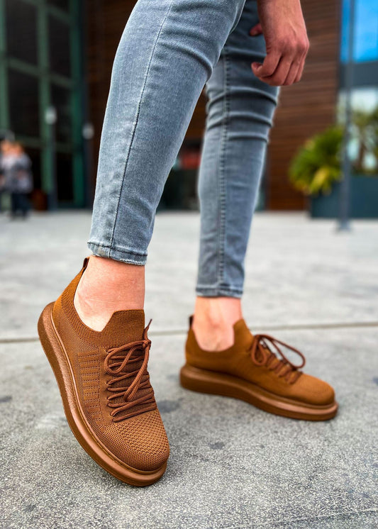Side shot of a pair of brown knit Torino sneakers featuring a lightweight sole and breathable fabric upper.
