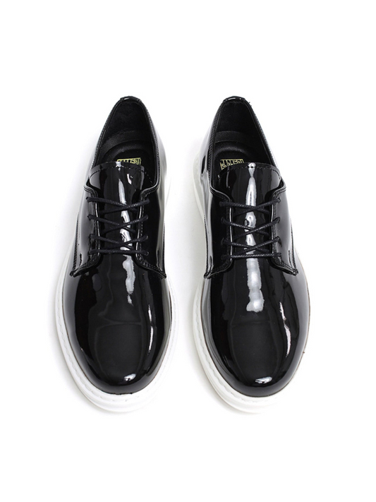 Black patent leather shoes on a white background