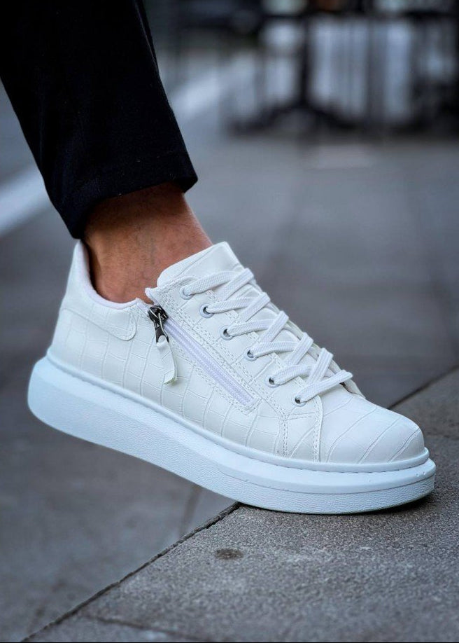 White sneaker with a zipper on a gray pavement background