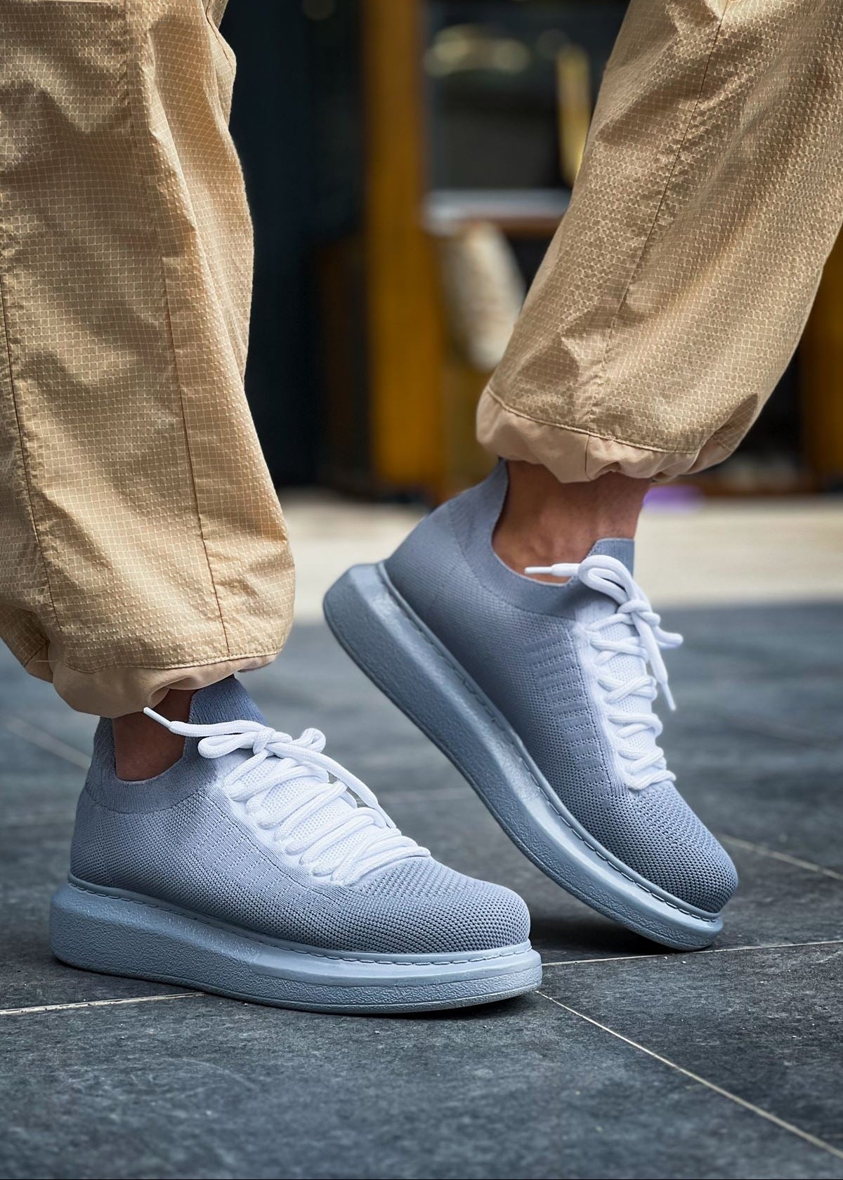 Light grey knit Torino Grey Peak sneakers with white laces and cushioned sole.