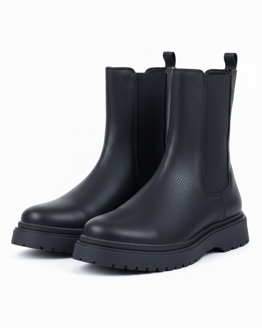 Side front view of Zenith Alaska Chelsea Boots by Apollo Moda in black textured leather with elastic panels and a chunky sole.
