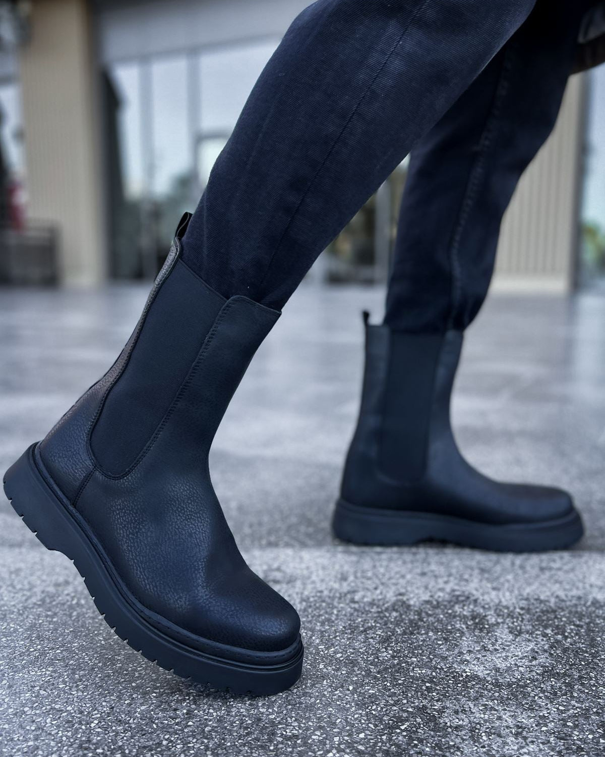 Lifestyle shot of Zenith Alaska Chelsea Boots by Apollo Moda in textured black leather with matching elastic panels and black soles.