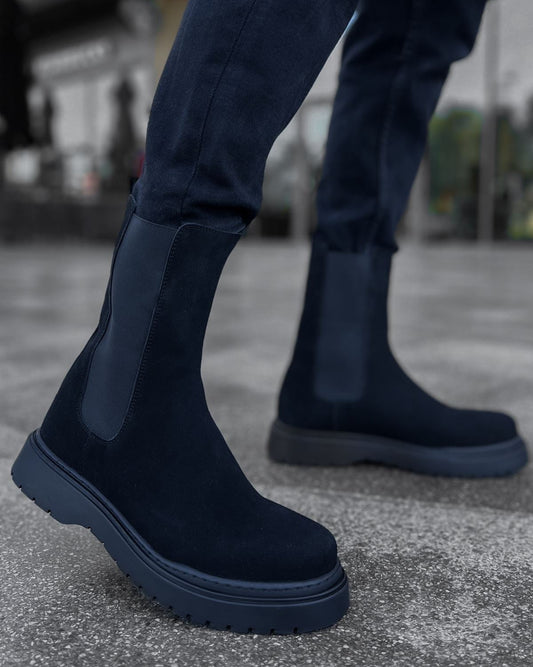 Lifestyle shot of Zenith Midnight Chelsea Boots by Apollo Moda in black suede with matching elastic panels and thick black soles.