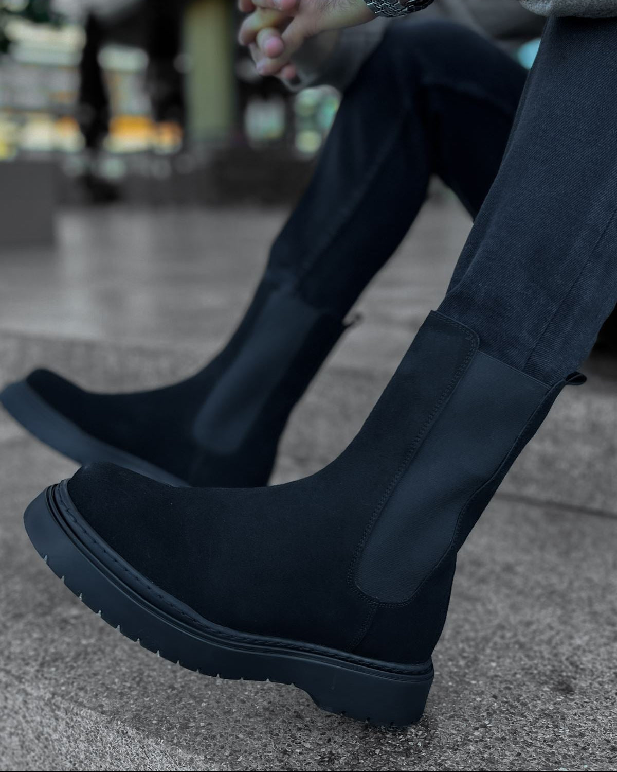 Lifestyle shot of Zenith Midnight Chelsea Boots by Apollo Moda in black suede with matching elastic panels and thick black soles.